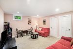 Lower level family room with TV is a great space to hang out, watch a movie, and challenge a friend to a board game